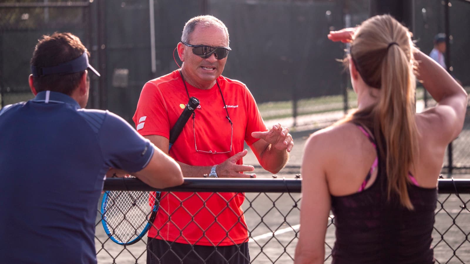 Nick Saviano speaking with a player and parent at the academy
